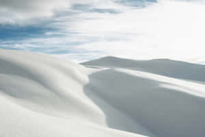 Serene Snowscape Undulating Hills Wallpaper