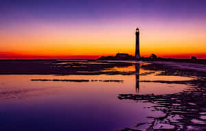 Serene Sunset Hues Over A Tranquil Ocean Wallpaper