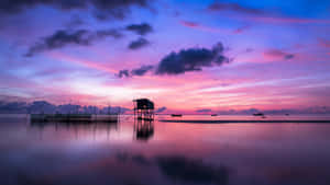 Serene Sunset Over Water Bungalow.jpg Wallpaper