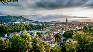 Serene View Of The Federal Palace Of Switzerland In Bern Against Sunset Sky Wallpaper