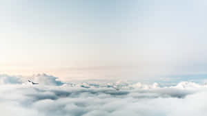 Serene View Of White Clouds Flowing Against The Blue Sky Wallpaper