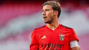 Serious Face Of Ruben Dias In Red Jersey Wallpaper