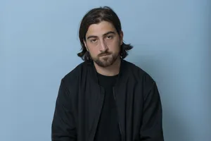 Serious Man Against Blue Background Wallpaper