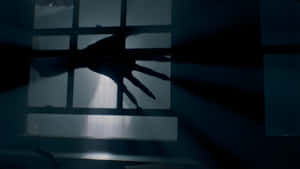 Shadowy Hand Reaches Through Window Wallpaper
