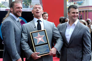 Shane Mcmahon With Vince Mcmahon And Triple H Wallpaper