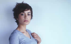 Shannyn Sossamon Posing With A Camera Wallpaper