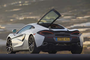 Sheer Sophistication - Mclaren 570gt On The Open Road Wallpaper