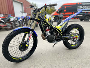 Sherco Racing Motorcycle Showing Off Its Power During An Off-road Event Wallpaper