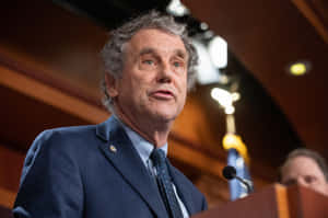 Sherrod Brown Speaking At A Podium Wallpaper