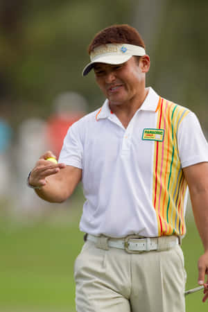 Shigeki Maruyama Poised With A Golf Ball Wallpaper