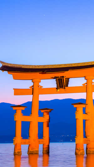 Shinto Torii Gate At Scenic Sunset Wallpaper