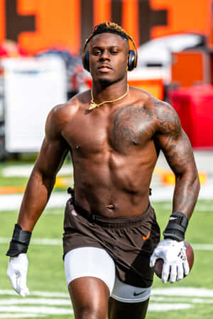 Shirtless Football Player Wearing Headphones Wallpaper