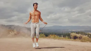 Shirtless_ Man_ Jump_ Roping_ Outdoors Wallpaper