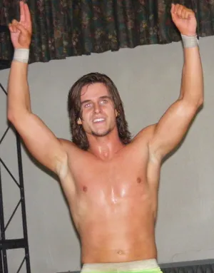 Shirtless Young Adam Cole With His Hands Up Wallpaper