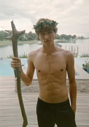Shirtless Young Man With Staffand Laurel Wreath Wallpaper