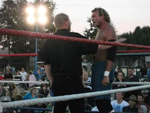 Sid Vicious Wrestling In The Ring With A Referee Wallpaper