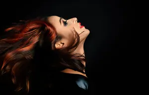 Side Profile Model's Flowing Red Hair Wallpaper