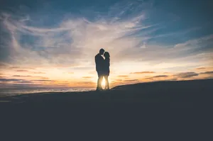 Silhouette Shot Of A Tangible Couple Under The Gorgeous Sky Wallpaper
