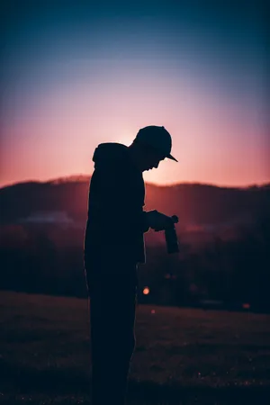 Silhouetted Photographerat Sunset Wallpaper