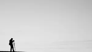 Silhouetteof Cameramanat Dusk Wallpaper