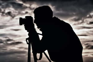 Silhouetteof Photographerat Dusk.jpg Wallpaper