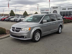 Silver Dodge Grand Caravan Dealership Lot Wallpaper