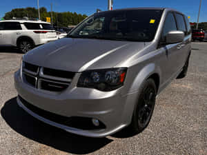 Silver Dodge Grand Caravan Parked Outdoors Wallpaper