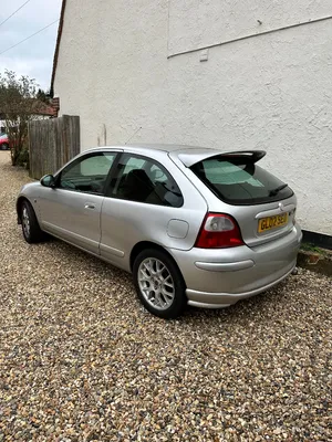 Silver Hatchback Car Parked Gravel Driveway Wallpaper