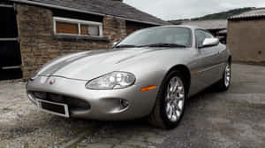 Silver Jaguar X K Coupe Parked Wallpaper