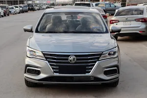 Silver M G5 Sedan Parked Outdoors Wallpaper