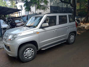 Silver Mahindra T U V300 Parked Outdoors Wallpaper