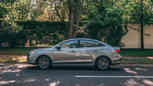 Silver Sedan Parked Street Side Wallpaper