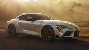 Silver Toyota Supra At Sunlit Road Wallpaper