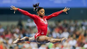 Simone Biles Powerful Split Jump Wallpaper