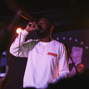 Singer Performance Under Red Lights Wallpaper