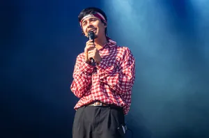 Singer Performingon Stage Wallpaper