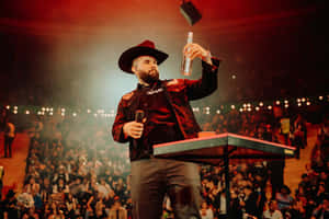 Singeron Stagewith Microphoneand Bottle Wallpaper