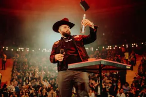 Singeron Stagewith Microphoneand Bottle Wallpaper