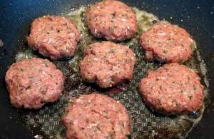 Sizzling Hamburger Patties Cooking Wallpaper