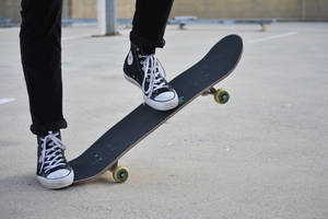 Skateboard With Colorful Chuck Taylors. Wallpaper