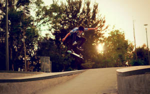 Skater Boy Nollie Trick At Sunset Wallpaper