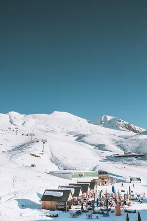 Ski Resort With Stunning Snowy Mountain View Wallpaper
