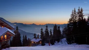 Ski Resort With Stunning Snowy Mountains Wallpaper