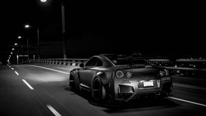 Skyline Car Driving At Night Wallpaper