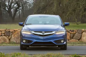 Sleek Acura Ilx Driving On A Scenic Road Wallpaper