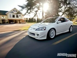 Sleek Acura Rsx Type-s In Motion On A Scenic Road Wallpaper