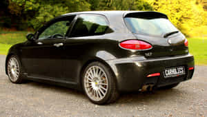 Sleek Alfa Romeo 147 On A Scenic Road Wallpaper