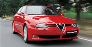 Sleek Alfa Romeo 156 Cruising On An Open Road Wallpaper