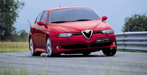 Sleek Alfa Romeo 156 In Classic Red Design Wallpaper