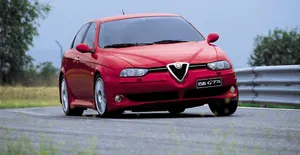 Sleek Alfa Romeo 156 In Classic Red Design Wallpaper